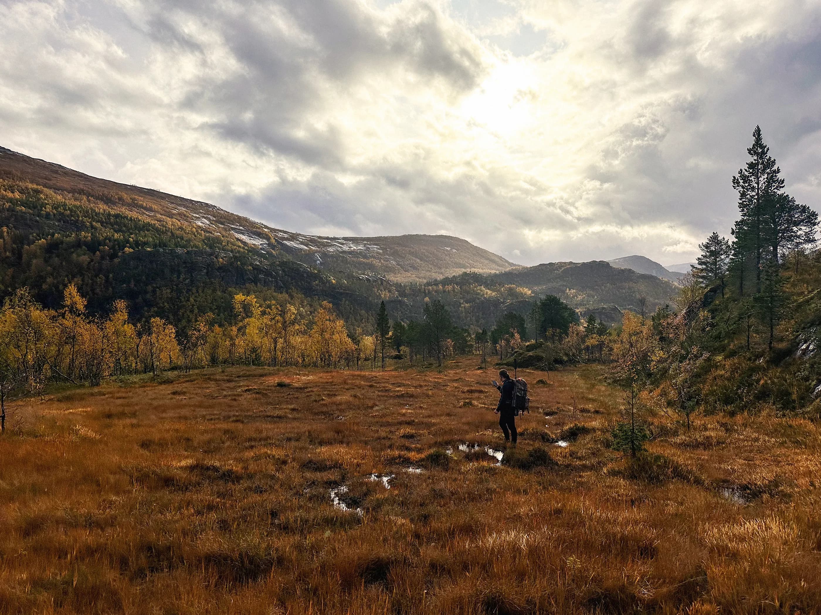 Mountain landscape with autumn colors and a hiker